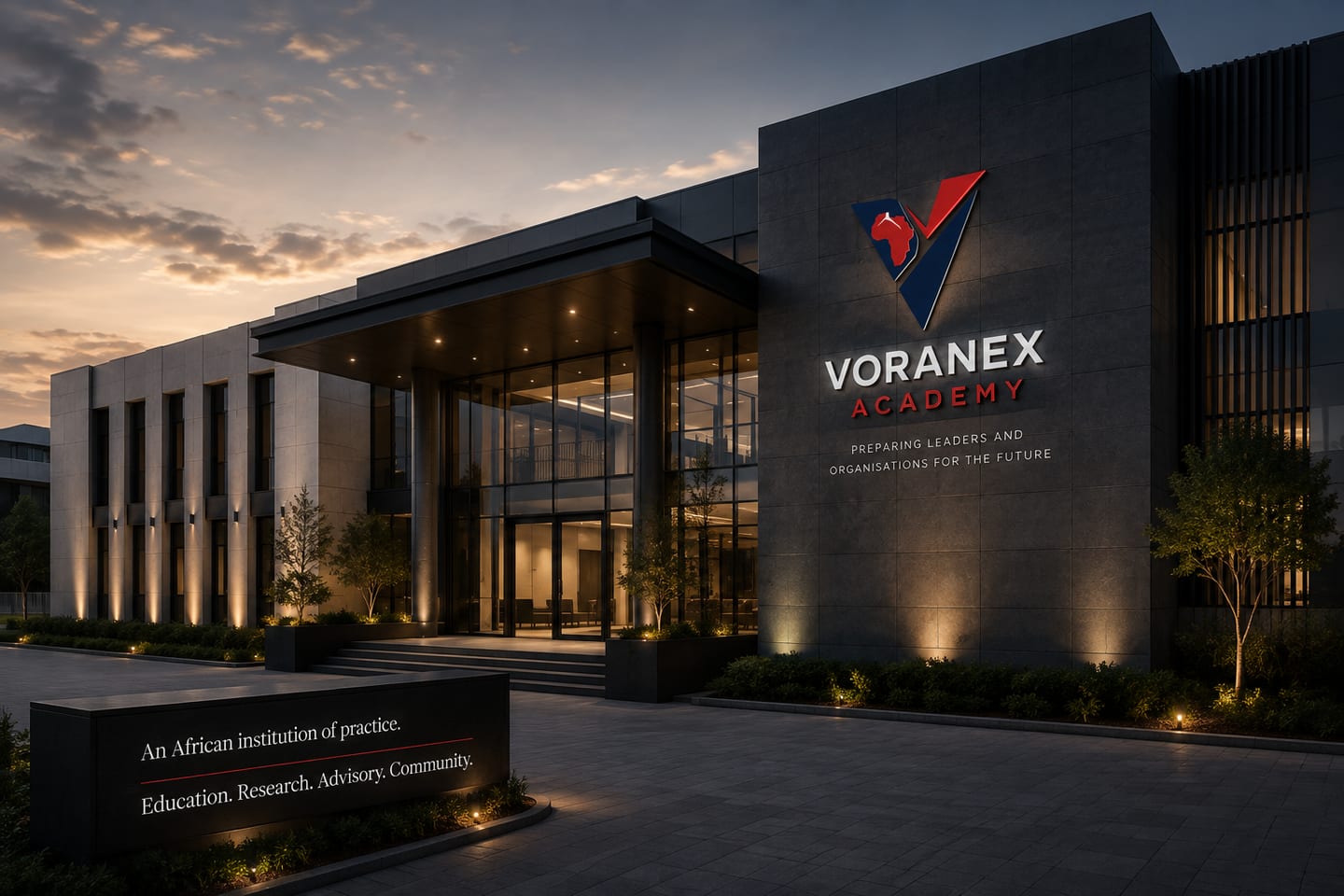 A rendering of a Voranex Academy building at dusk, the lit lockup on its facade above a sign reading “An African institution of practice.”