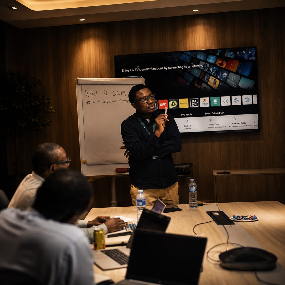 A facilitator putting a question to the room beside a flip chart.